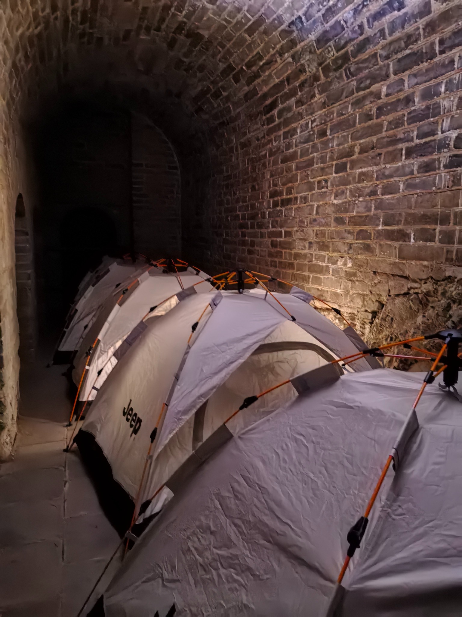 Tents arranged inside the brick arches of a Great Wall watchtower